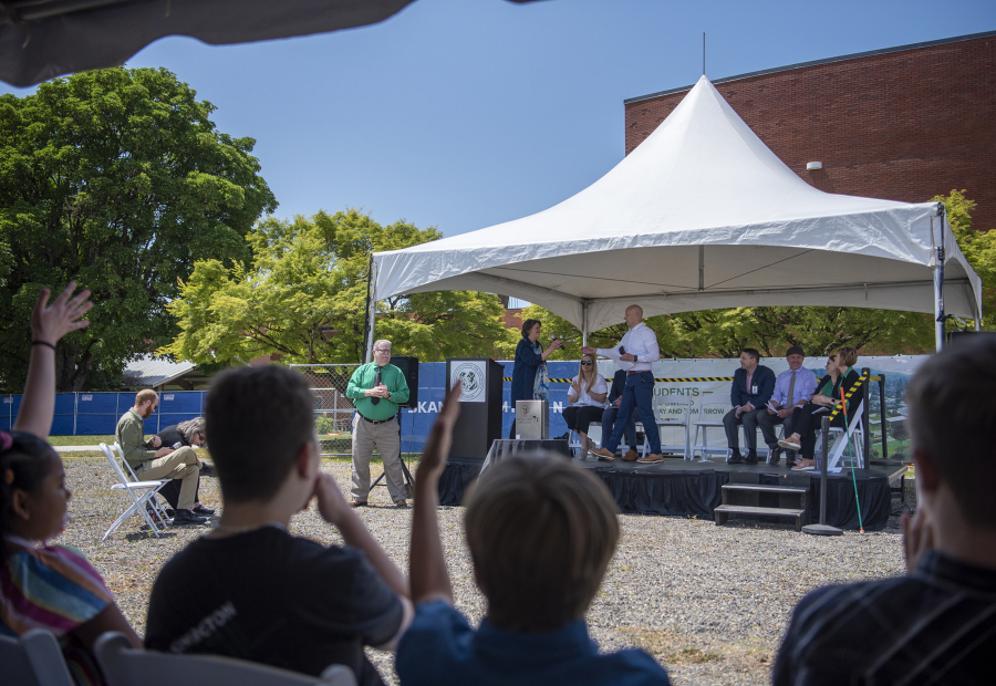 At left, people applaud and listen to speakers Thursday during a groundbreaking ceremony for the Center for Deaf and Hard of Hearing Youth at Washington School for the Deaf. The school will open a new academic building and gymnasium in 2024 -- the school's first major construction in 50 years. (Taylor Balkom/The Columbian)